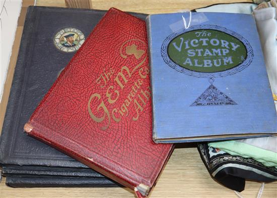 Four cigarette albums and a stamp album